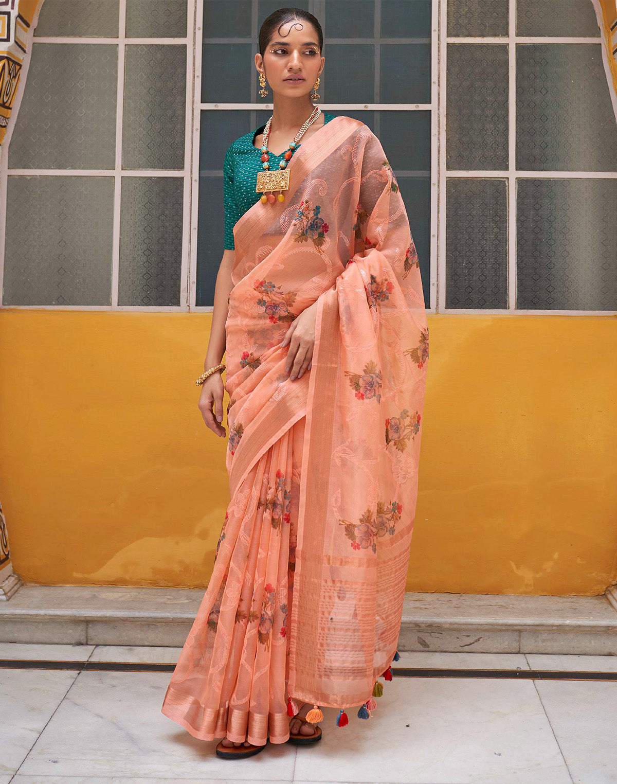 Peach Organza Floral Print Saree With Tussels and Contrasting Blue Blouse