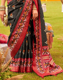 Alluring Black Patola Silk Floral Print Saree